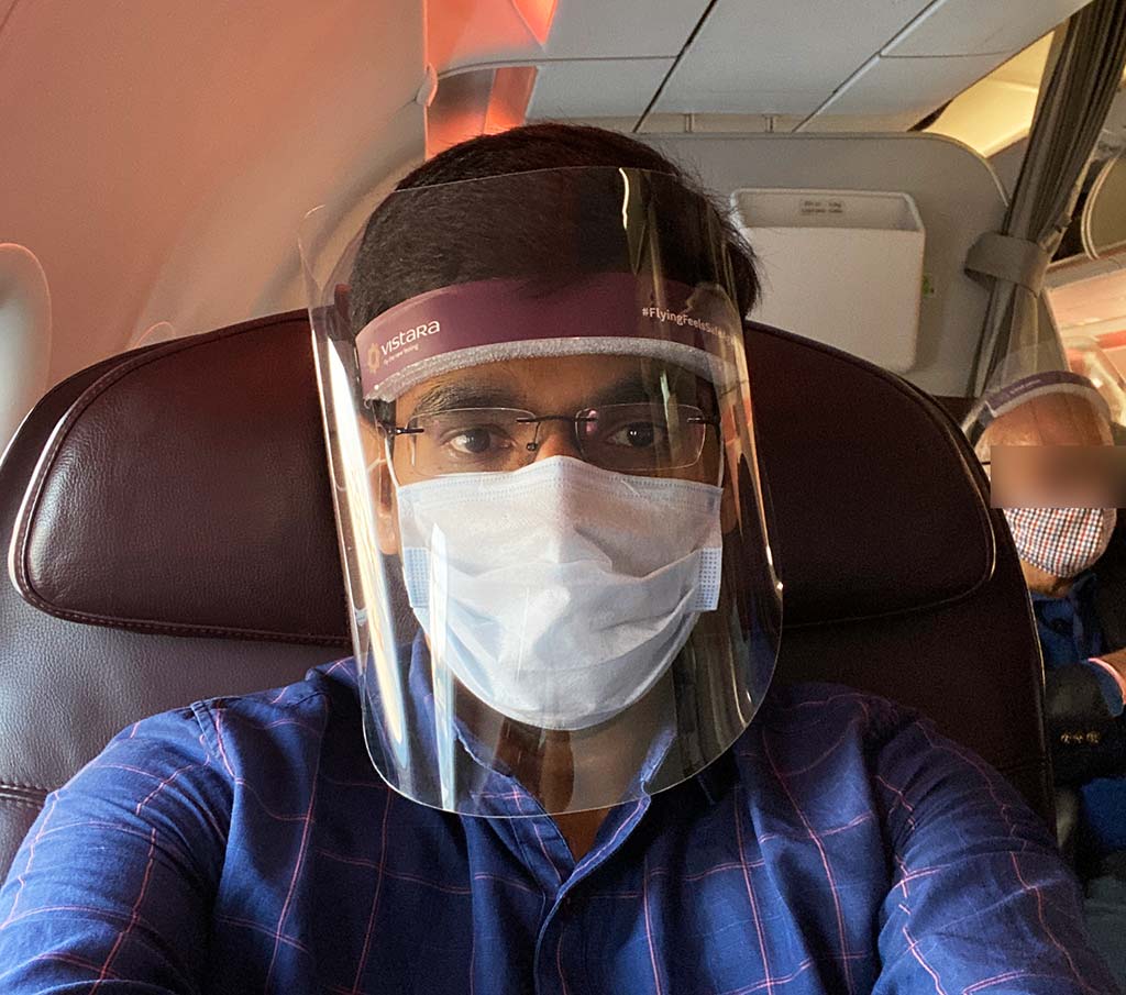 On Vistara Business Class seat with covid mask and shield